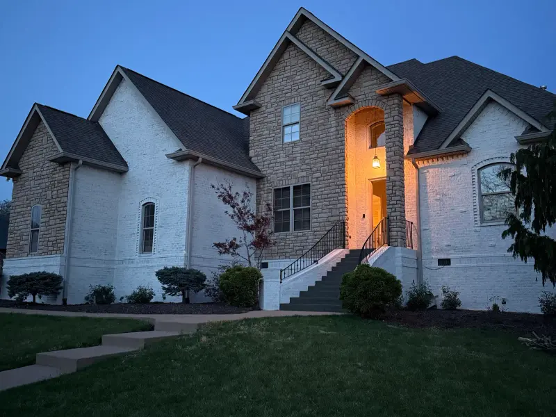 Stone-and-brick home at dusk, exterior painting by Mr. Wu's Painting
