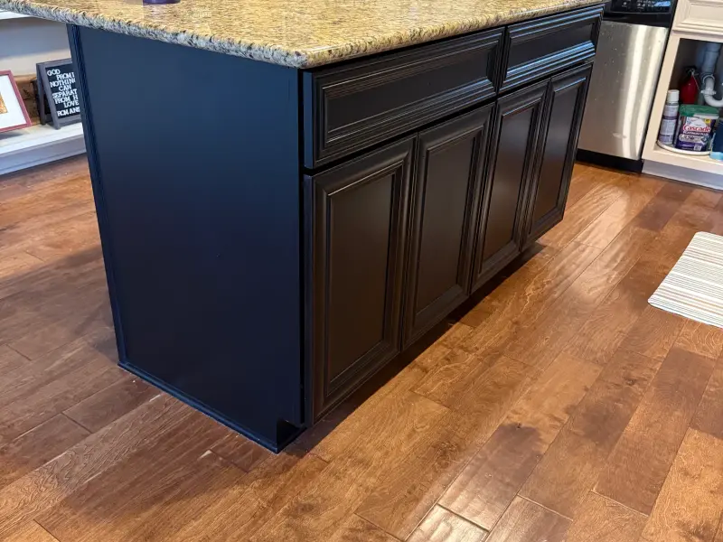 Kitchen island painted navy blue with black cabinet doors